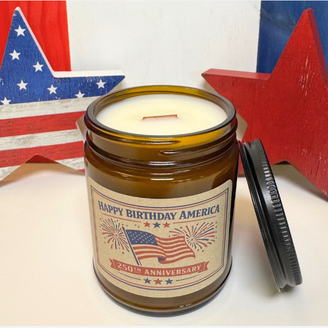 Candle in a jar with 'Happy Birthday America' label against an American flag background